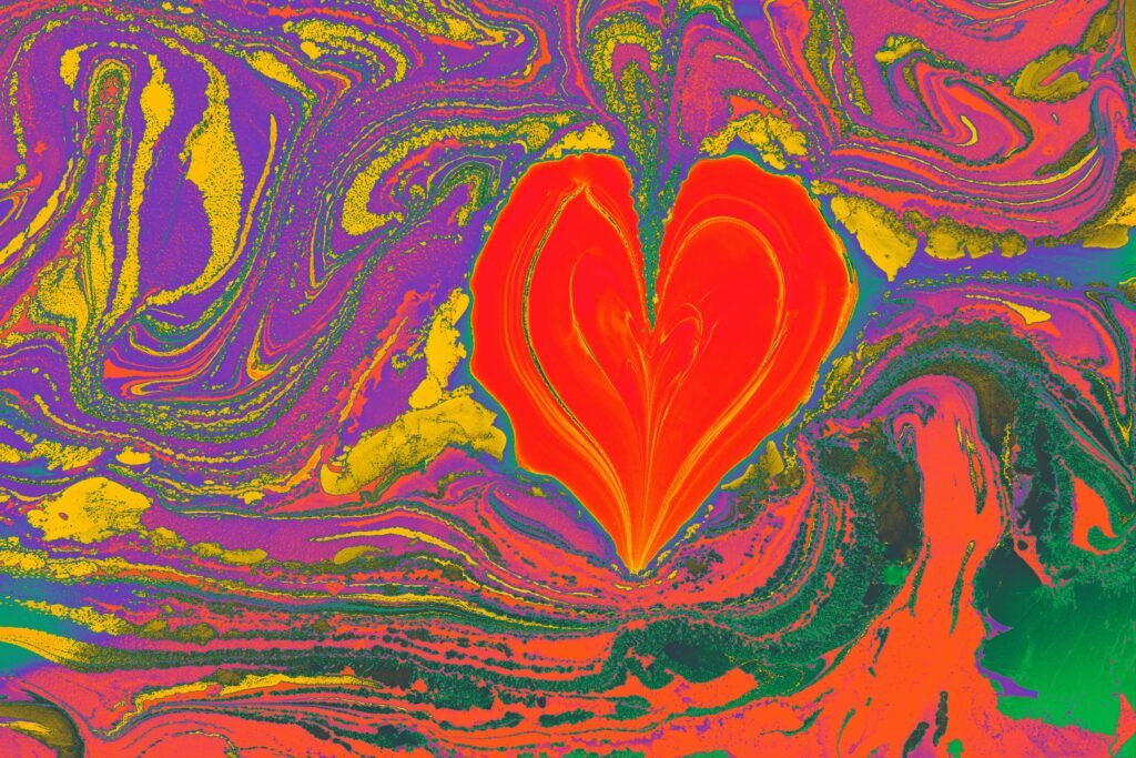 pexels-photo-15260304-15260304 A vibrant and colorful marbled artwork featuring a heart shape with abstract swirls.