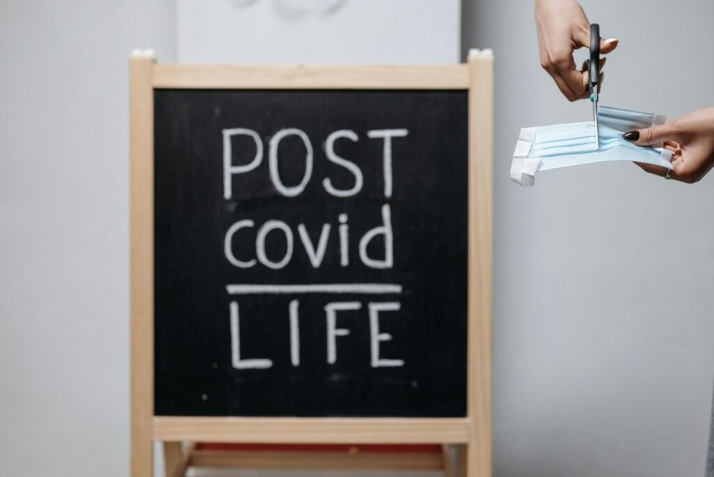 pexels-photo-8111475-8111475 Chalkboard message with a mask cutting symbolizes transition to post-COVID life.
